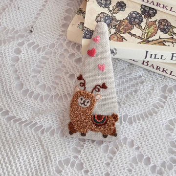 Decorative ribbon with llama design on a textured surface with Jill Barker soap bars.