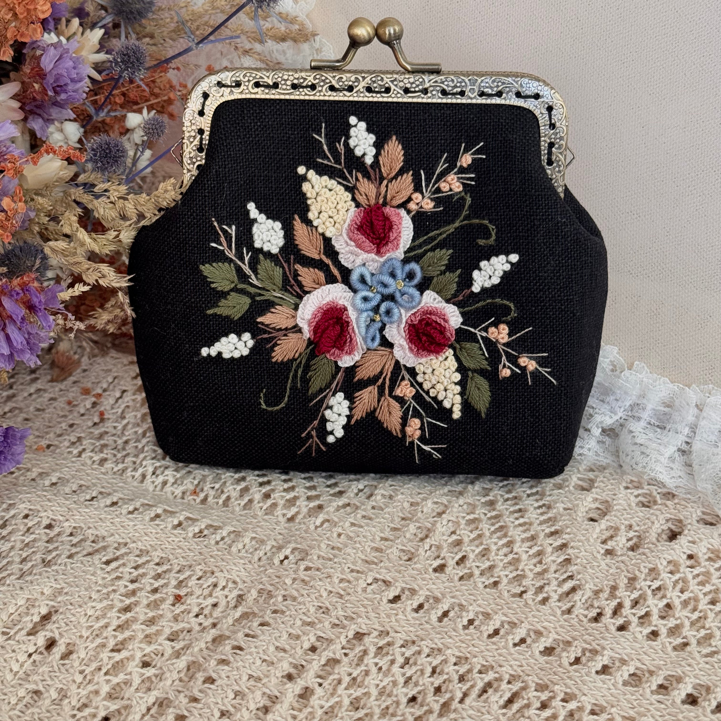 Käsin kirjottu kukkaro, punainen ruusu-aiheinen kuvio kankaalla